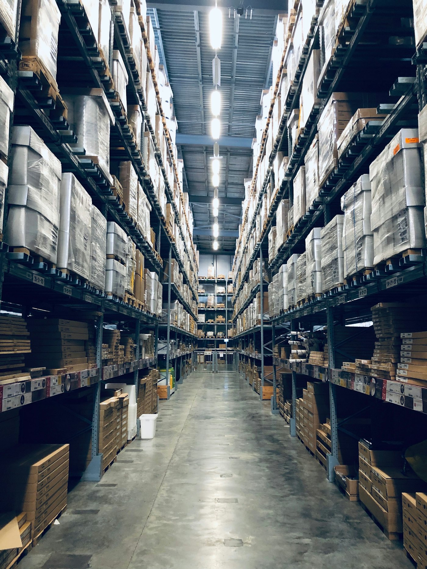 Stocked warehouse aisle with racked goods